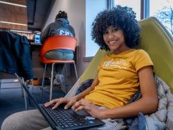 Montclair State University student studying on laptop.